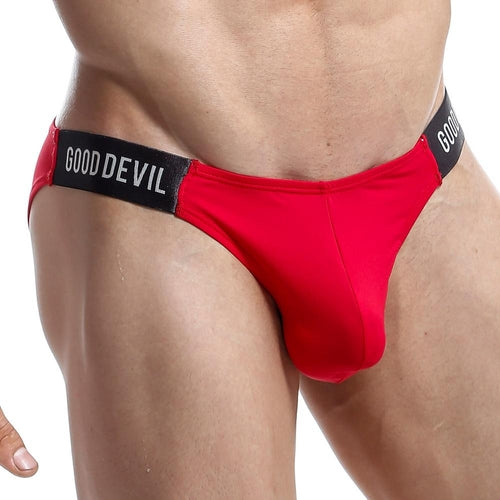 A persons lower torso is shown in a Good Devil Micro Bikini, featuring black elastic bands with the GOOD DEVIL brand on them, set against a white background.