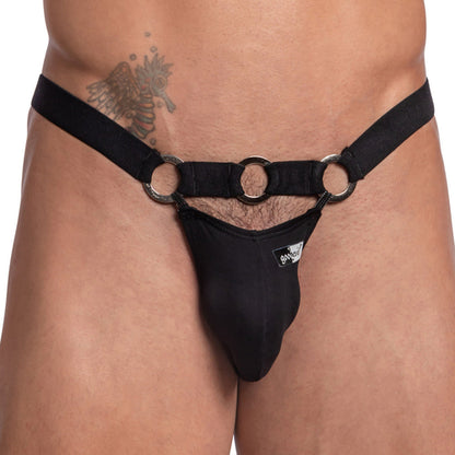 A person is wearing the Good Devil Bikinis with a steel ring waistband, featuring a minimalist black design and a branded patch on the front, complemented by an angel tattoo on the right hip.