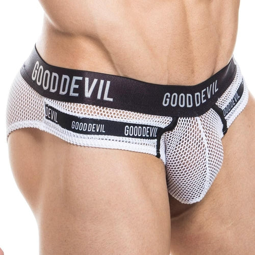 A person wearing Good Devil Show It All Briefs with a black waistband adorned with the GOOD DEVIL text is viewed from the side, emphasizing the see-through net-like texture and supportive pouch fit.