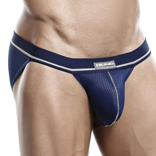 A model dons the Hung Jockstrap, featuring blue mesh with a silver waistband and trimmings for enhanced support. The brands logo is prominently displayed on the front. The focus is on the midsection and thighs against a plain white background.