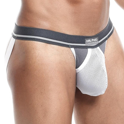 A close-up of someone wearing the Hung Expose Jockstrap by Hung shows off its sexy style, featuring an innovative waistband design with striking white and blue mesh and branded details.