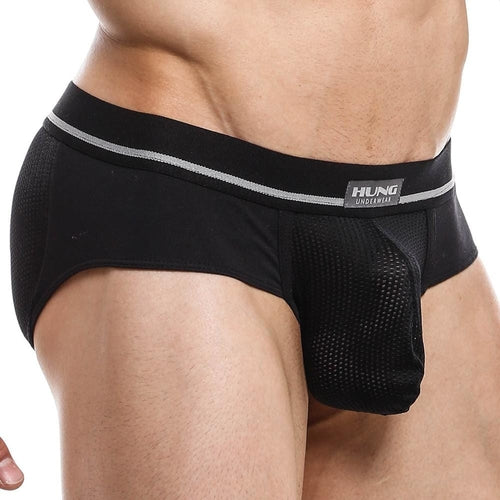 A person wears the black Hung Jockstrap, featuring a gray waistband with the HUNG logo. The textured fabric is fitted with a breathable mesh pouch, emphasizing comfort and design in mens underwear. The image highlights the lower torso.