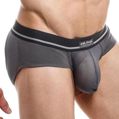 A person wearing Hungs gray jockstrap showcases the mens design, featuring a breathable mesh pouch and stylish waistband.