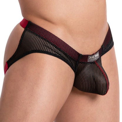 A close-up image shows a person with light skin tone wearing the Hung The Colosseum Jockstrap, featuring black and red mesh with a branded waistband. This mens jockstrap is form-fitting and partially transparent, made from breathable mesh fabric.