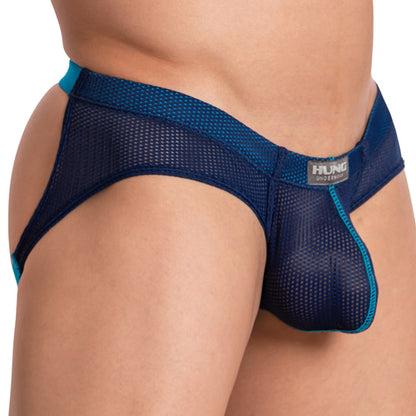 A person wearing the Hung The Colosseum Jockstrap, featuring breathable mesh fabric in blue with turquoise trim and a supportive pouch design for comfort, complete with a visible Hung brand label on the waistband.