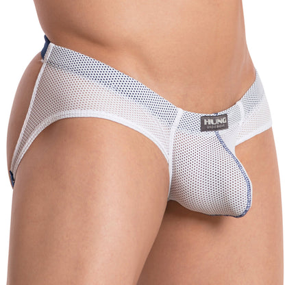A close-up shows a person wearing the Hung The Colosseum Jockstrap, crafted from breathable white mesh with blue accents. The elastic band features the Hung logo, highlighting fit and style, emphasizing comfort and fashion.