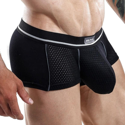 A person is wearing the black Hung Boxer Trunk by Hung, featuring a supportive waistband and body-hugging fit. The breathable, textured underwear with subtle detailing contrasts against their skin on a plain white background.