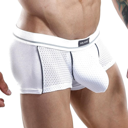 A person wearing the Hung Boxer Trunk, made from premium perforated fabric for comfort. The breathable design features mesh material and a supportive waistband, emphasizing a body-hugging fit around the midsection from the front.