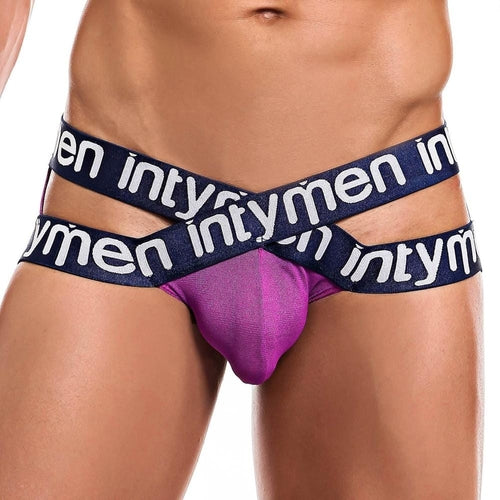 A person wearing the chic Intymen Cross Jockstrap, showcasing intymen on purple and blue straps. This bold design features crossed blue elastic bands and a prominent pouch, epitomizing modern mens fashion with its versatile appeal.