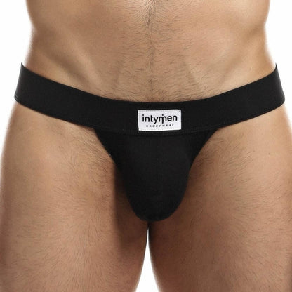 A person wearing Intymen Proud Jock is shown from waist to upper thighs. The jock has a broad waistband displaying Intymen, providing a supportive fit and contoured pouch for comfort.