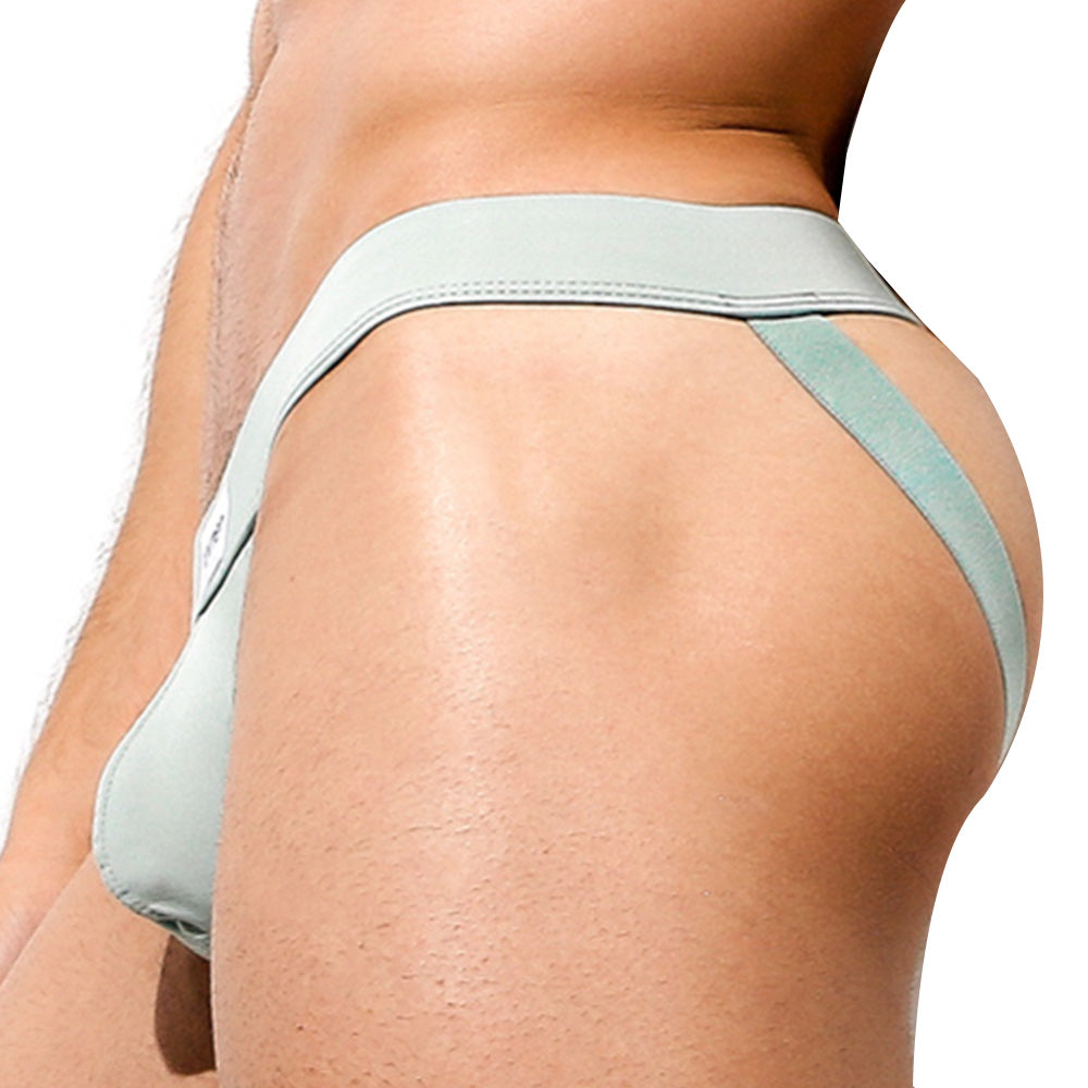 Close-up of someone wearing light green Intymen Proud Jock, featuring a supportive fit with dual hip straps. The side view showcases the contoured pouch of this Intymen product.