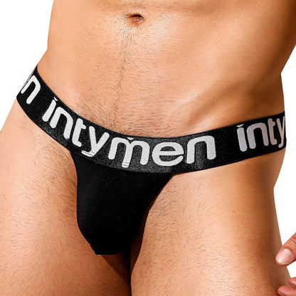 A close-up shows a person wearing the Intymen Good Jockstrap. The band is black with intymen in white, providing comfort and support. The skin above the snug waistband highlights its secure fit.