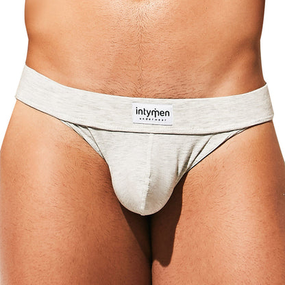 A person wears the Intymen Loving Jockstrap featuring a supportive thick waistband labeled Intymen. The comfortable cotton-spandex blend offers a flawless fit against a plain white background.