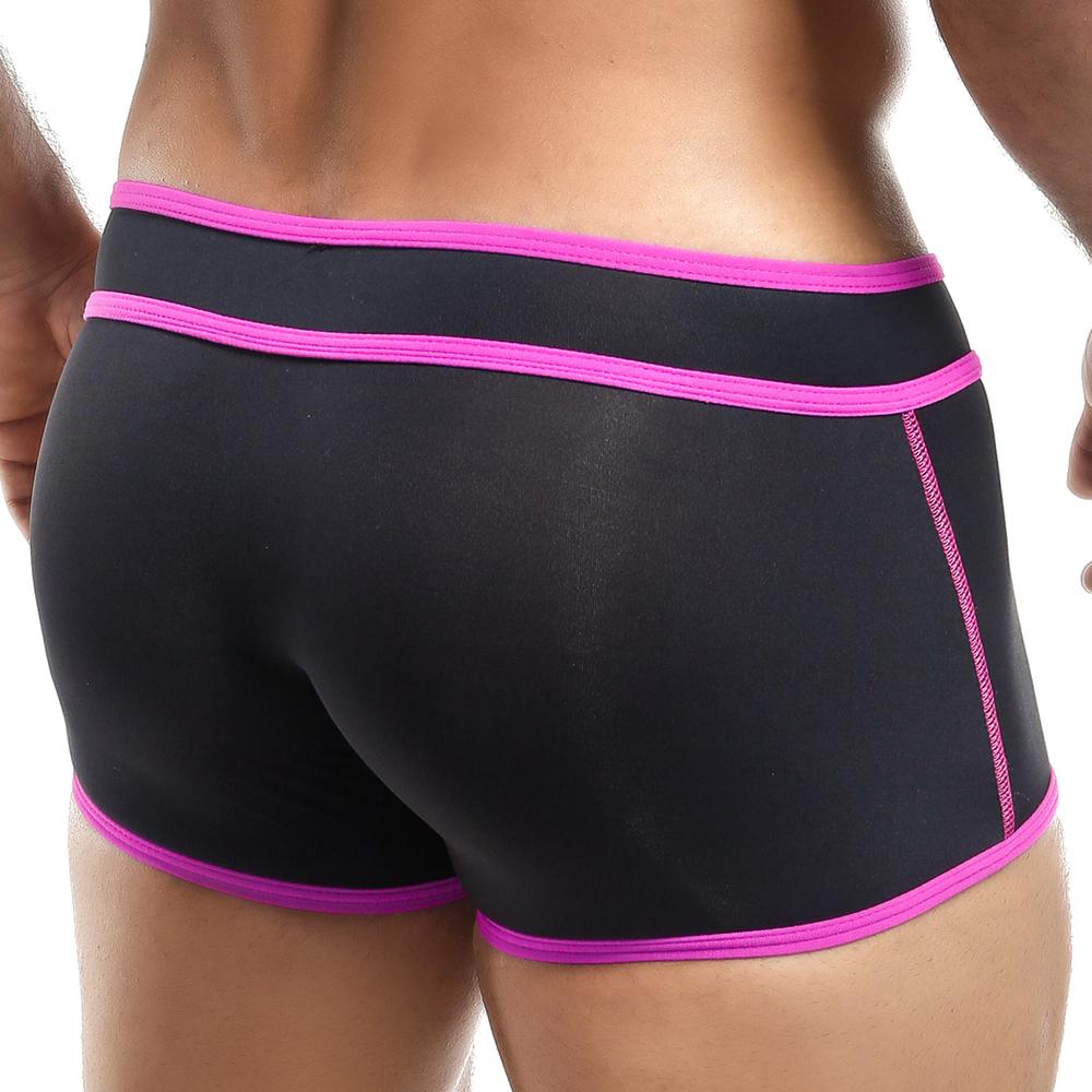 The Intymen Boxer Trunk by Intymen is shown from the back, featuring black fabric with bold contrast piping and vibrant pink trim that accentuates its form-fitting design, making a striking style statement.