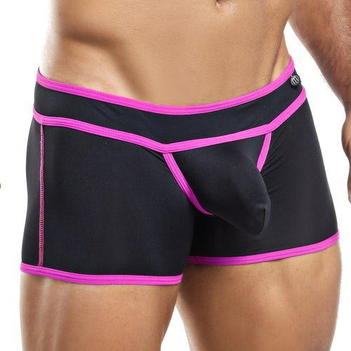 A person models the Intymen Boxer Trunk featuring a bold design with a protruding front pouch and striking black contrast piping with pink trim, highlighting its stylish fit and unique flair.