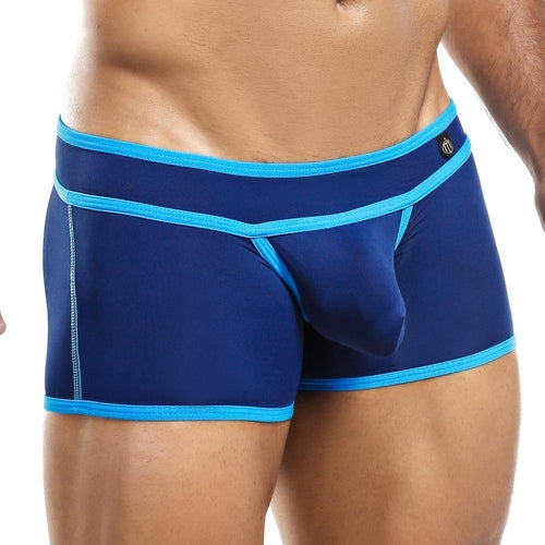 A person models the Intymen Boxer Trunk with bold contrast piping, visible from chest to mid-thigh, highlighting its provocative design and fit.