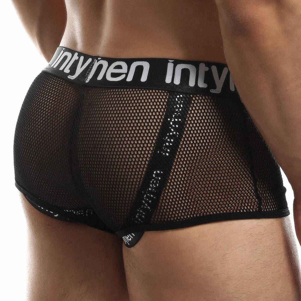 An individual is wearing Intymen Jock Mesh Cover boxer briefs in black, with a supportive design featuring a white waistband labeled intymen. The breathable mesh fabric is transparent, with black seams outlining the edges.