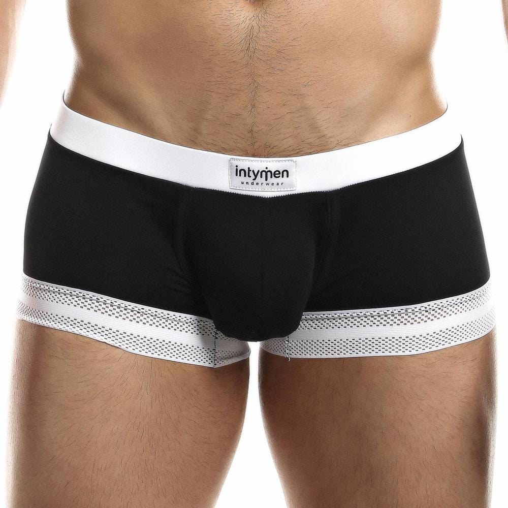 A person wearing Intymen Quads Trunk boxer briefs displays black and white mesh legs. The premium fabric and tailored fit offer comfort and style, with Intymen on the waistband. The photo highlights the underwear from the waist down.