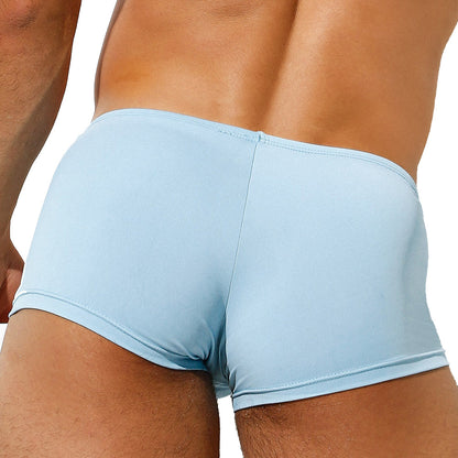 A person models the Intymen Di Blu Boxer Trunk in light blue, showcased from the back to emphasize the lower back and upper legs, underlining the all-day comfort and fit of its supportive pouch design.