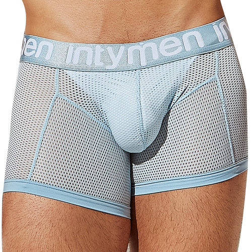 Close-up of a person wearing Intymen ING081 Luxury Trunk Boxer in light blue mesh, with intymen on the waistband, made from premium fabric for an exquisite feel and featuring a contouring pouch for optimal comfort.