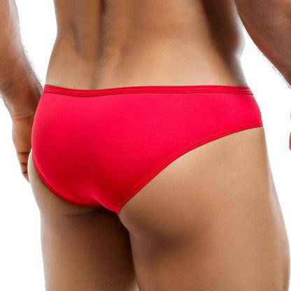 A model wearing the Intymen Bikini, a high-cut red piece by Intymen, is shown from the back. The focus is on the garment and lower back, emphasizing its sleek design against a plain white background.