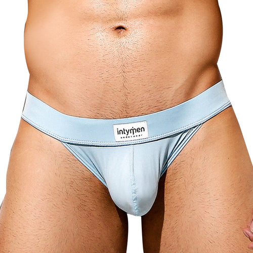 A person in Intymen Obscene Bikini light blue underwear showcases a high-cut design, snug fit, and branded waistband, offering comfort and excellent support while highlighting the midsection.