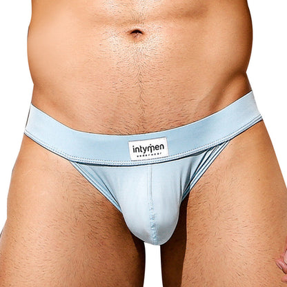 A person in Intymen Obscene Bikini light blue underwear showcases a high-cut design, snug fit, and branded waistband, offering comfort and excellent support while highlighting the midsection.