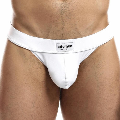 A close-up of someone wearing the Intymen Obscene Bikini emphasizes its comfortable fit and branded waistband. The focus is on the midsection, highlighting the sleek design and high-cut style.