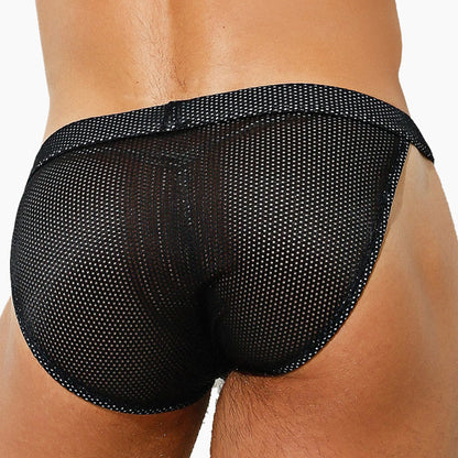 The person is wearing the Intymen Palatino Bikini, designed by Intymen. Made from sheer fabric with small mesh holes, it fits snugly, enhances breathability, and highlights the lower back and hip against a plain white background.