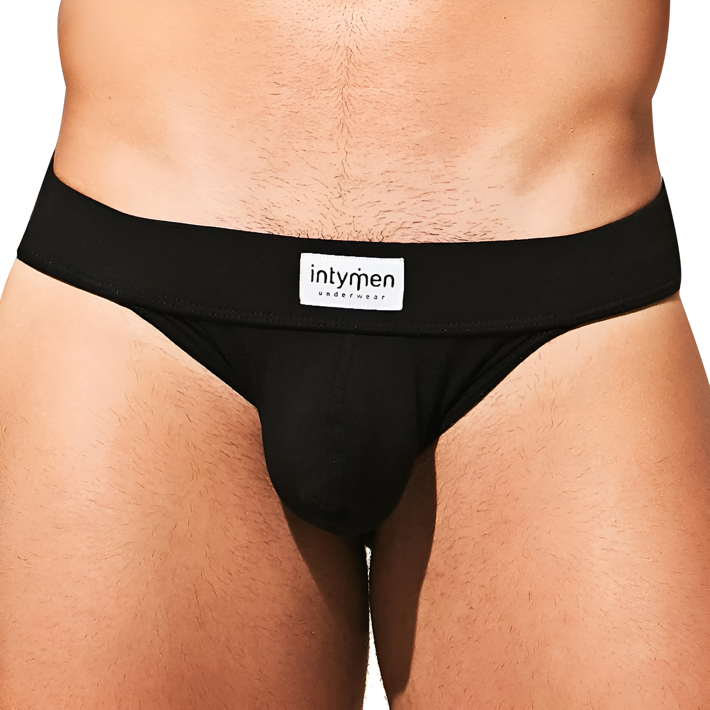 The image shows a person wearing black Intymen Fresh Bikini briefs with Intymen on the waistband, crafted from a premium fabric blend. The focus is on the midsection to highlight the design and fit of this bikini-style underwear.