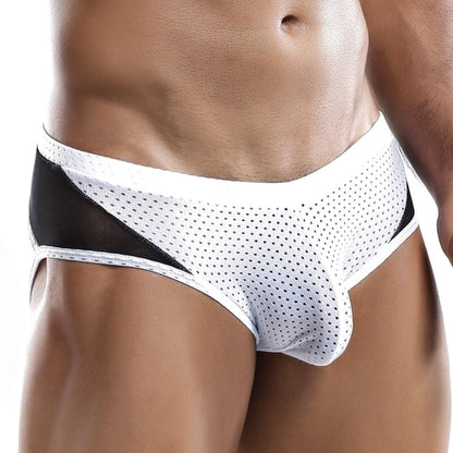 A person wears Intymen Serenity Briefs with breathable white mesh and black sheer side panels. The contour pouch enhances comfort, while the image focuses on the lower torso and legs, highlighting the design and fit.