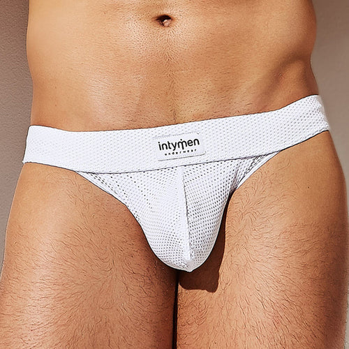 Close-up of a person wearing the Intymen Mesh Seductive Thong, featuring its unique V-shape design and breathable mesh texture. The Intymen brand name is prominently displayed on the waistband, emphasizing both style and comfort.