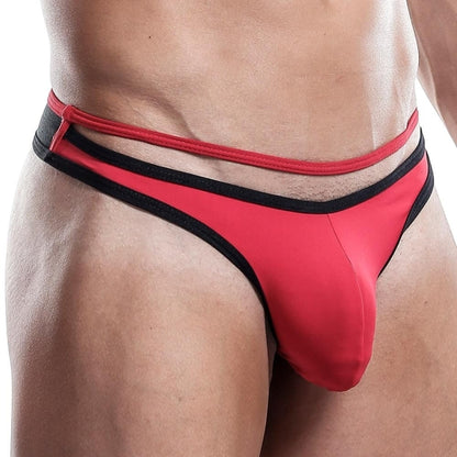 A person models Kyle G-String athletic underwear in red and black, featuring a distinctive double waistband and supportive pouch. The photo emphasizes the lower torso and hip area, showcasing the strings innovative design.
