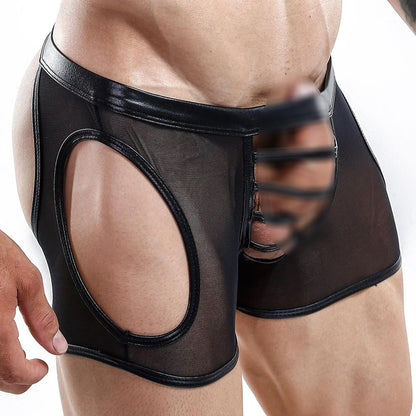 Someone wearing the Miami Jock Jockstrap by Miami Jock, showcasing its seductive shiny black mesh with cut-out sides and a strappy front design, highlighting the unique and premium fabric of this alluring garment.