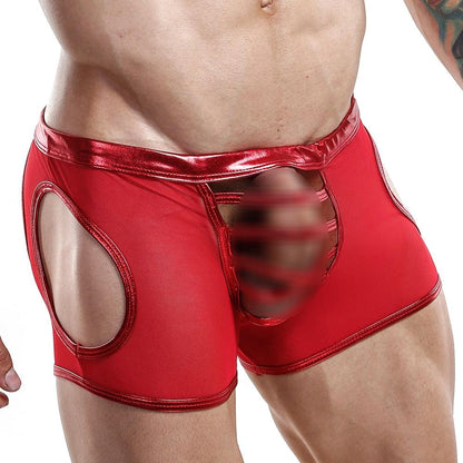 A person wears Miami Jocks shiny red jockstrap featuring side mesh cutouts and a front circular opening, crafted from premium fabric with a decorative element. This bold, unconventional design is irresistibly seductive.