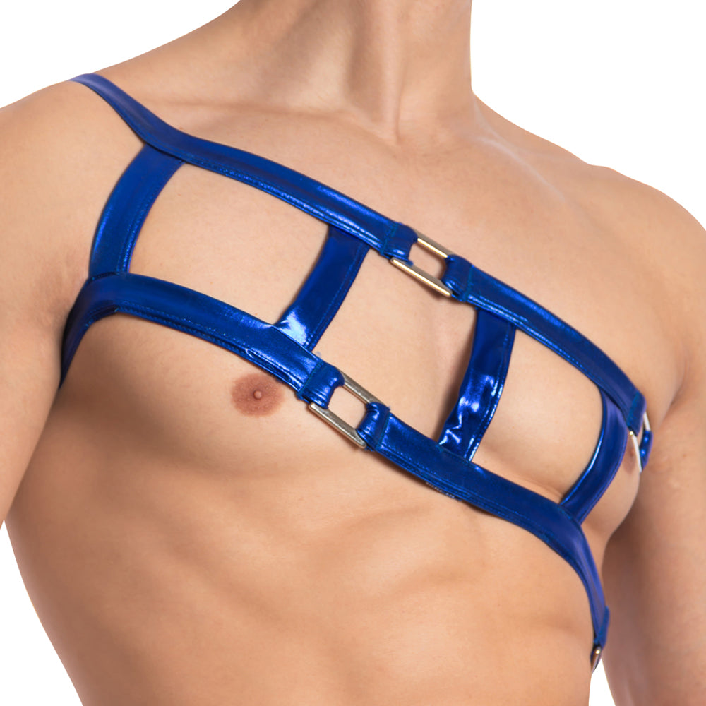 A close-up of a Miami Jock Accessory Harness in shiny blue features precise chest-crossing straps. Metal rings create a sexy geometric pattern, showcasing a bold fashion statement on a shirtless individual.