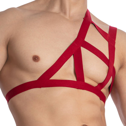 Close-up of an individual wearing Miami Jock Accessories Multi Straps, a unique red harness made from premium fabric with an asymmetrical design over the shoulder and chest against a plain white background.