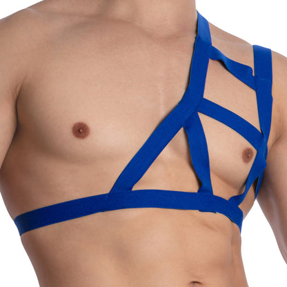 A person is wearing a Miami Jock Accessories Multi Straps harness in blue, featuring geometric lines that highlight the torso while covering the left shoulder. Made from premium fabric, this distinctive harness pops against a plain white background.