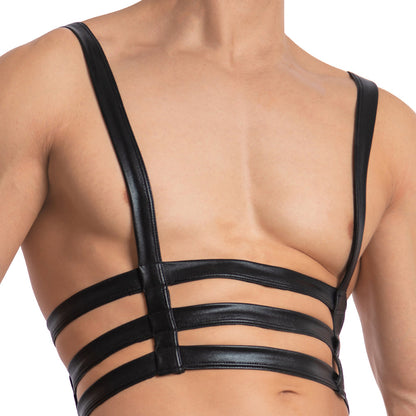 Someone wearing a Miami Jock Bodysuit, an enticing accessory by Miami Jock, showcases a sleek black leather design with double straps across the chest.