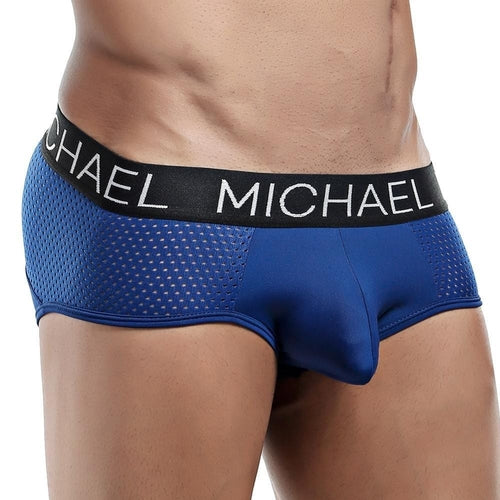 A person wears the sleek Michael Brief, a defining fit blue mesh brief with a black waistband featuring MICHAEL in white letters, highlighting its style, comfort, and support for the lower torso and hips.