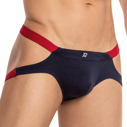 Wearing Pistol Petes Toro Jock, featuring navy blue athletic-style briefs with red side elastic bands and a small front logo. Inspired by bull design, it includes a supportive pouch for enhanced comfort and style.