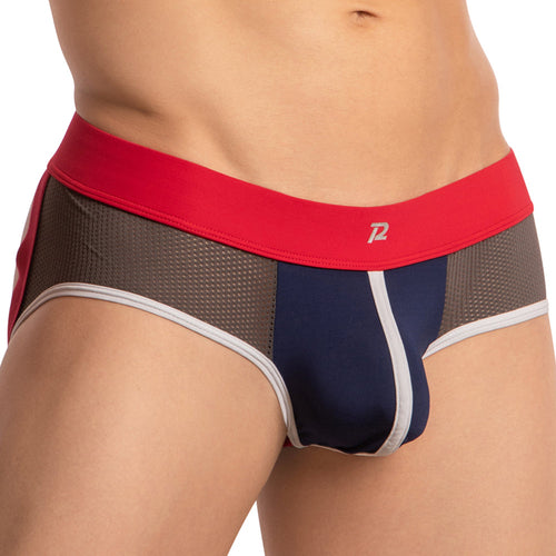A close-up of a person wearing fitted, multi-colored briefs highlights the Pistol Pete Piping Bulge Pouch Jockstrap. Ideal for mens intimate wear, it has a red waistband, navy blue and gray fabric, white trim, and features mesh with side net accents that blend seamlessly.