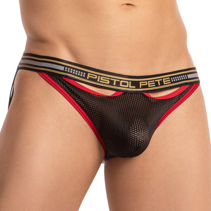Someone is seen wearing the Pistol Pete Fishnet Pouch Jockstrap, featuring black mesh with red trim and a Pistol Pete waistband. The design includes cutout sections near the waistband, similar to an enticing fishnet style. The image highlights the lower torso.