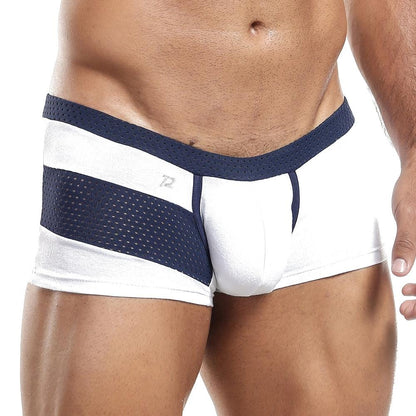 Someone is wearing the Pistol Pete Boxer Trunk in white and navy, showcasing its mesh side panels. The focus is on the lower torso, emphasizing the athletic design details and supportive pouch of these briefs.
