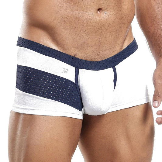Someone is wearing the Pistol Pete Boxer Trunk in white and navy, showcasing its mesh side panels. The focus is on the lower torso, emphasizing the athletic design details and supportive pouch of these briefs.