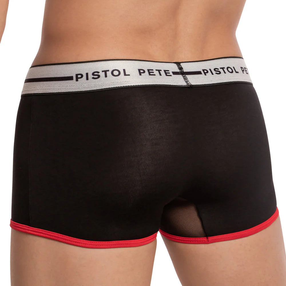 A person sports the Pistol Pete Shower Trunk in striking black with a bold white waistband displaying Pistol Pete, featuring red trim and sheer fabric on the back for sophistication.