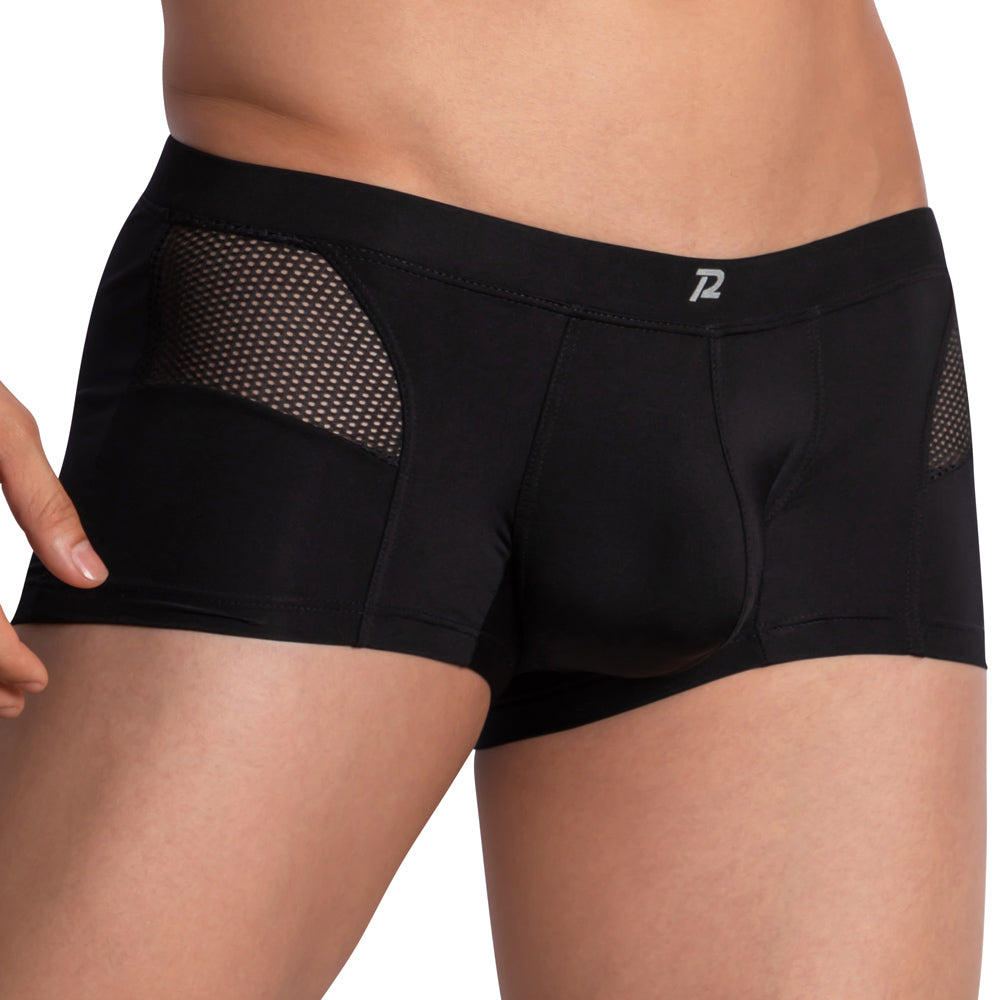 Someone is wearing Pistol Pete Side Mesh Boxer, which features a contour-enhancing pouch and mesh sides. The waist and upper thigh area are highlighted, with the briefs displaying a small logo on the waistband.