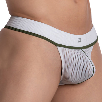 A close-up shows a person in a daring Pistol Pete Half Naked Thong. The white mesh with green trim reveals the luxurious fabric texture, and its subtle logo on the waistband promises unparalleled comfort.