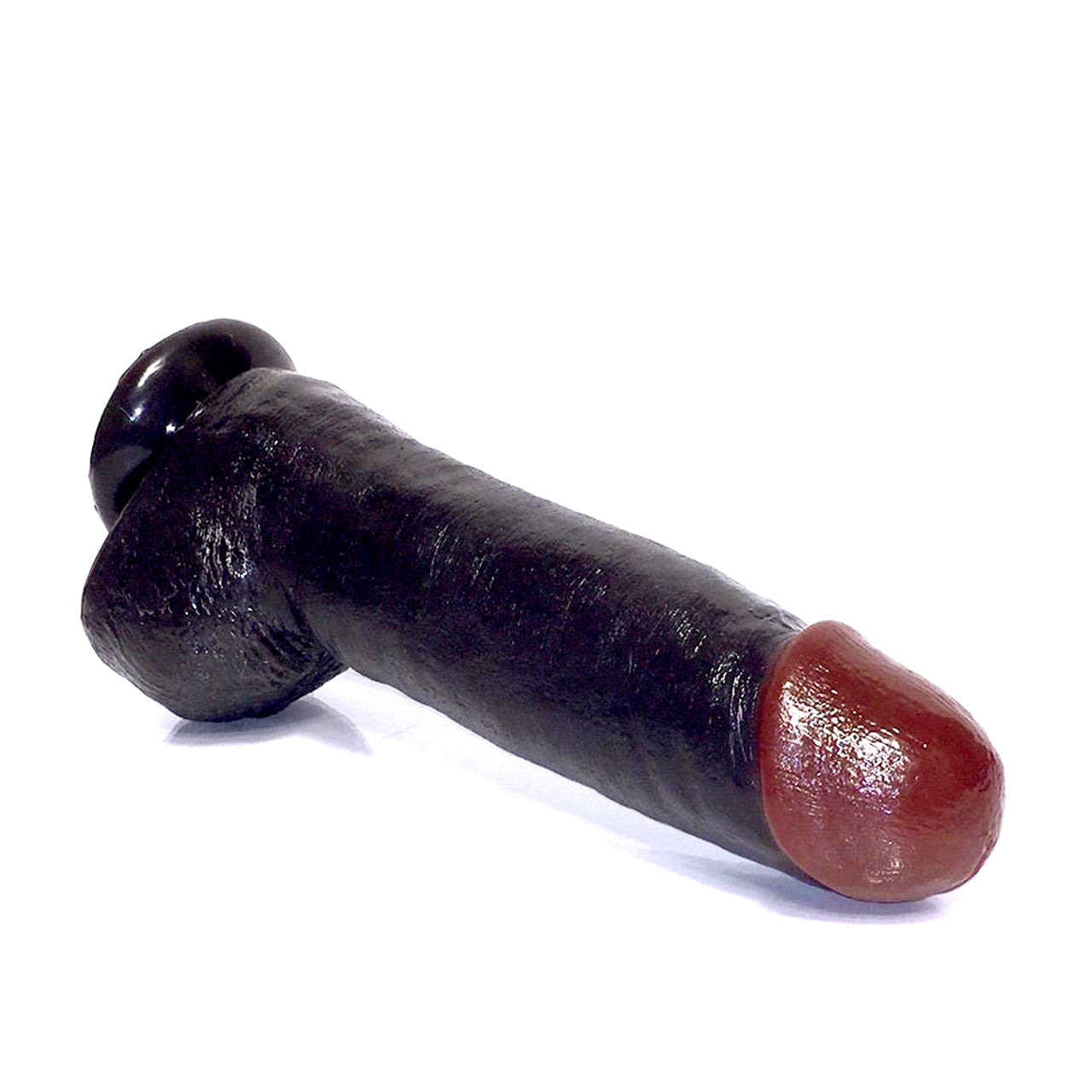 The Rascal Toys Black Balled 12 Cock With Balls, featuring realistic detailing and a pronounced tip, rests on its side against a plain white background.