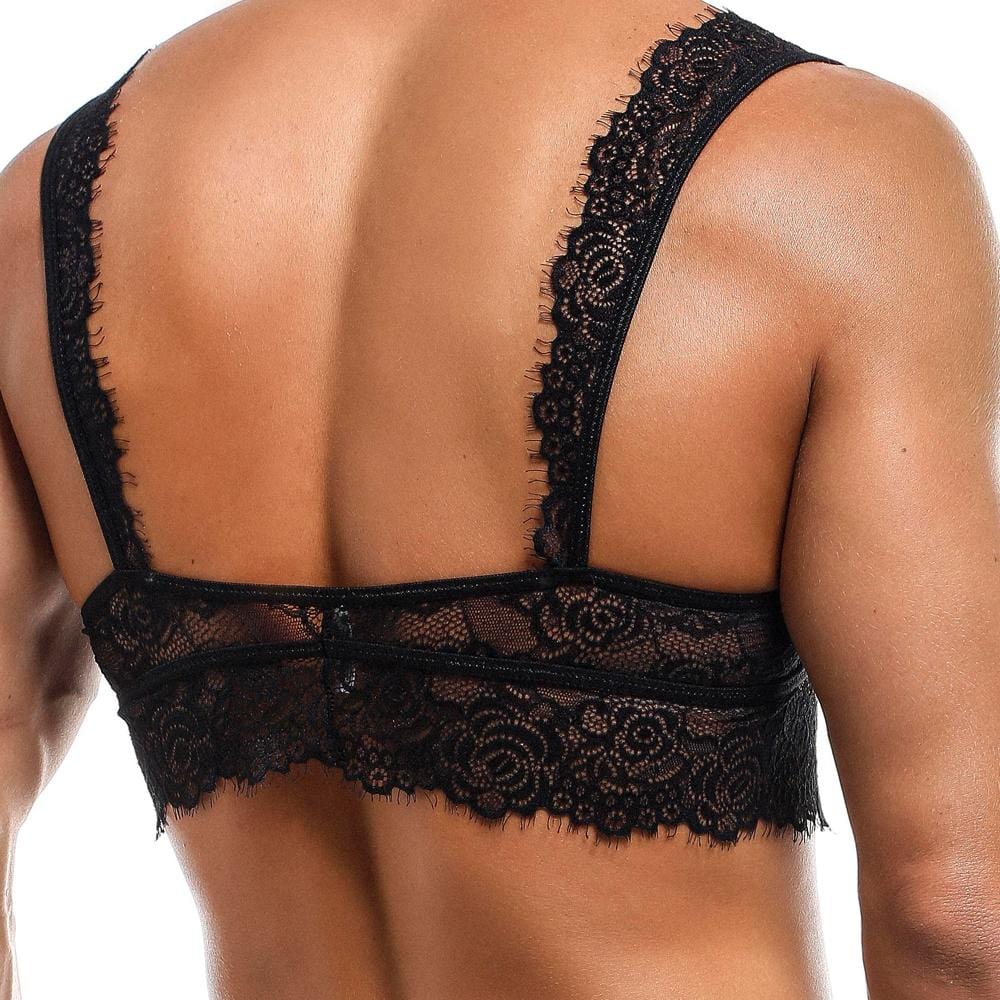A person wearing the Secret Male Low Cut Bra by Secret Male, featuring a black lace design with floral patterns, blending intimate mens fashion with intricate lace straps and an elegant scalloped edge.